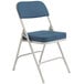 A National Public Seating gray metal folding chair with a blue padded seat.