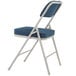 A National Public Seating gray metal folding chair with a blue padded seat.