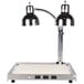 A silver Alto-Shaam CS-200 heated dual lamp carving station on a white counter.