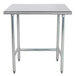 An Advance Tabco stainless steel work table with metal legs.