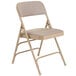 A National Public Seating beige metal folding chair with a beige fabric padded seat.