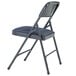 A National Public Seating metal folding chair with a blue padded seat.