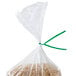 A bag of rice with a green paper tie around it.