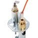 A close-up of a Pilot Burner with a white object and orange and white device on it.