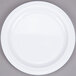 A white Thunder Group Nustone melamine plate with a white rim on a gray surface.