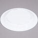 a white plate on a gray surface