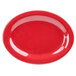 A close-up of a red oval platter with speckled specks.