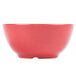 A close up of a red bowl with a white background.