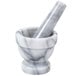 A close-up of a white marble Thunder Group mortar and pestle set.