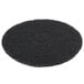 A black Scrubble by ACS stripping floor pad with a circular pattern.