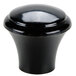 A close-up of a black round plastic knob.