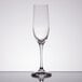 A close-up of a Spiegelau Vino Grande flute glass on a reflective surface.