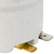 A white ceramic cylinder with metal pieces.