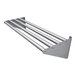 A stainless steel wall mounted drainage shelf with four tubular bars.