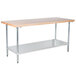 An Advance Tabco wood top work table with a galvanized metal base and undershelf.