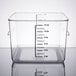A clear square Rubbermaid food storage container with black measuring lines.