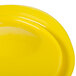 A yellow Rubbermaid food storage container lid.