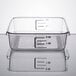 A clear square Rubbermaid food storage container with measurements on it.