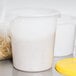 A white Rubbermaid food storage container with a yellow lid.