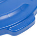 A blue plastic Rubbermaid BRUTE lid with text on top.