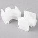 A close-up of two white plastic pieces.