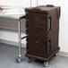 A dark brown Cambro Ultra Camcart food pan carrier on wheels.