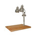 A chrome Hanson Heat Lamps carving station with two lights shining on a maple block.