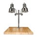 A Hanson Heat Lamps dual lamp chrome carving station on a wooden surface.