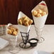 American Metalcraft cardboard fry cones filled with food on a table.