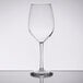 A Libbey customizable tall wine glass with a stem on a reflective surface.