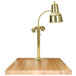 A brass Hanson Heat Lamp on a maple block base.