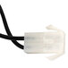 A white cable with a black connector plugged into a white plastic object.