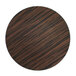 A circular wood surface with brown and black stripes.