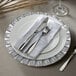 A white plate with a jeweled mirror finish on a white background.