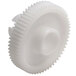 A close-up of a white plastic gear with a hole.