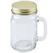 A Libbey glass mason jar with a gold metal lid and handle.