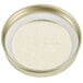 A Libbey gold metal Mason jar lid on a white surface.