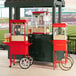 A red Carnival King popcorn machine on a counter.