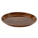 A Cambro round fiberglass tray with a brown Burma teak finish.