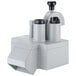 A close-up of a grey Robot Coupe vegetable prep machine with two black cups.