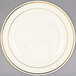 A Fineline Silver Splendor plastic plate in white with gold bands on the rim.