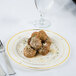 A Fineline Silver Splendor plastic plate with meatballs and a fork on it.