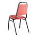 A red Lancaster Table & Seating banquet chair with black metal frame and padded seat.