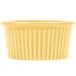 A yellow fluted ramekin with a striped pattern.