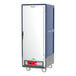 A white and blue Metro C5 heated holding cabinet with wheels.