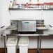 A stainless steel TurboChef countertop conveyor oven.