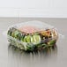 A Dart ClearSeal plastic container with a salad inside.