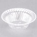 A clear Fineline plastic bowl with a rippled edge.