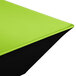 A green square melamine bowl with a black base.