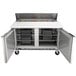 A Beverage-Air stainless steel refrigerated sandwich prep table with two doors and a cutting board lid.